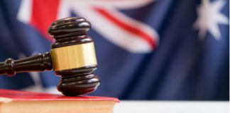 Australia - Gavel and legal book on wooden table