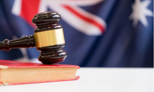 Australia - Gavel and legal book on wooden table